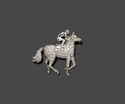 Lot 700 - A Diamond Set Horse Brooch, the trotting horse with jockey mounted set with round brilliant cut...