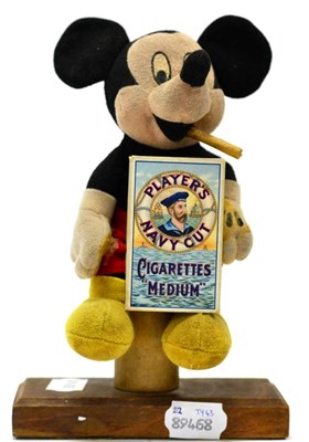 Lot 3414 - Mickey Mouse Soft Toy the figure has been positioned on a wooden stand smoking a cigar with a...