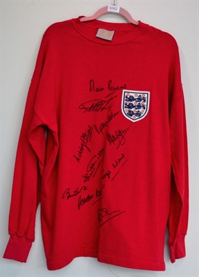 Lot 3042 - World Cup 1966 England Signed Retro Shirt red with three lions badge, signed by 10 team...
