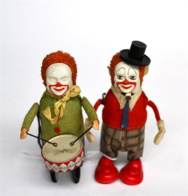 Lot 3378 - Schuco (Germany) Two C/w Clowns one playing drum (G) another with plastic shoes and hat (G, but...