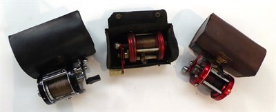 Lot 111 - Three Abu Ambassadeur Multiplying Reels, comprising two 6000's in red (one a/f) and a 6000C in...