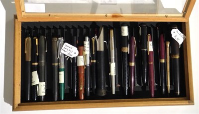 Lot 180 - Sixteen Mixed Pens in a Glazed Display Case, includes Parker and Swan fountain pens, Biro,...