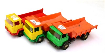 Lot 405 - Hammer (West Germany) Three Tipper Trucks plastic in varying colours (G-F, one back detached....