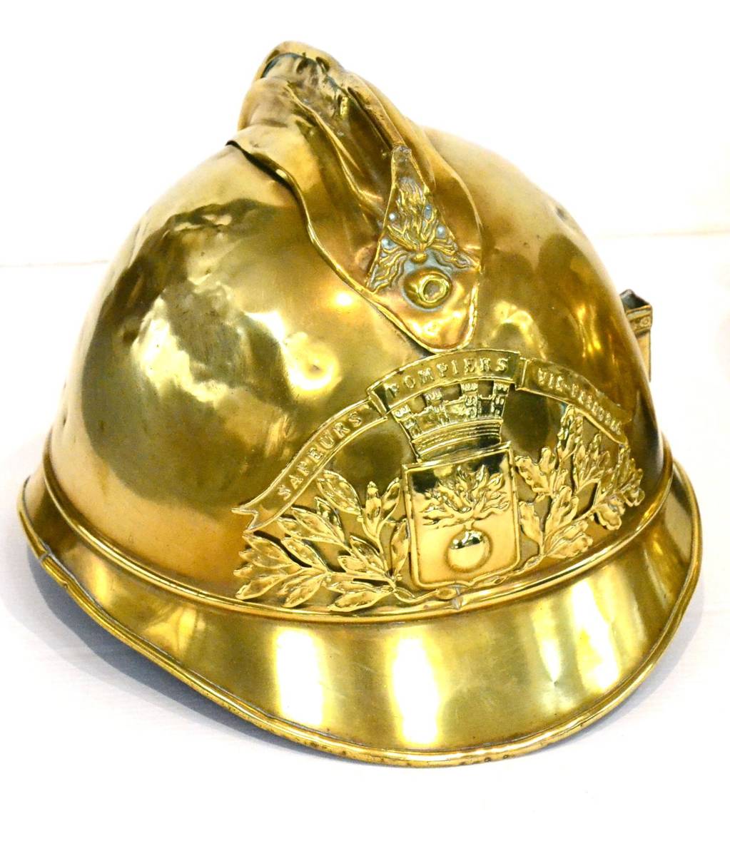 Lot 212 - French Brass Fire Helmet From Vic Yeyensa Fire Service with crest to front (G, some denting)