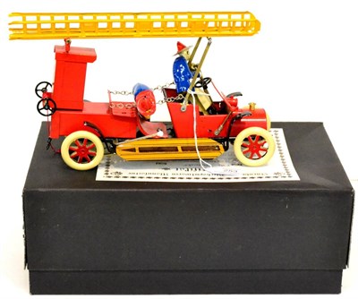 Lot 253 - Tucher & Walther T182 Fire Engine with two figures, raising ladder and bell, in original box...