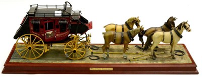 Lot 341 - Franklin Mint Wells Fargo Stage Coach on display plinth (two horses tail broken off, one missing)