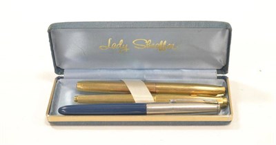 Lot 1007 - Lady Sheaffer A Pair Of Fountain Pens with 14K nibs and coloured metal cases, in powder blue...