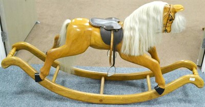 Lot 1015 - Rocking Horse (Modern) constructed in varnished wood with twin curved rockers, leather saddle...