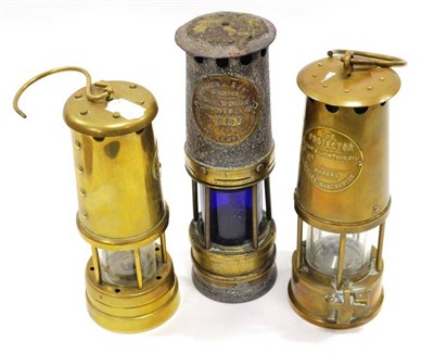 Lot 1018 - Three Miner's Lamps Ackroyd & Best Type 01 No.350 with blue glass, (corroded to top), The Protector