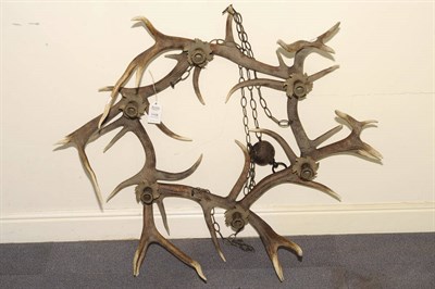 Lot 1158 - A Red Deer Antler Framed Hexagonal Ceiling Corona, 20th century, supporting six gilt metal and leaf