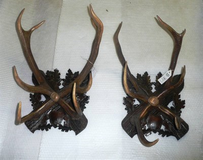 Lot 1165 - A Pair of Red Deer Antler Coat Hooks, circa 1900, in cruciform arrangement, on carved and...