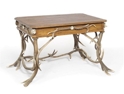 Lot 1170 - A German Antler Mounted Walnut Writing Table, circa 1880, canted rectangular, slim frieze...