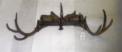 Lot 1175 - An Austro-German Antler Mounted Coat Rack, 1878, composed of a rustic wooden bar with fallow...