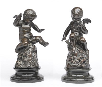 Lot 1197 - A Pair of Bronzed Metal Figures of Putti, French, circa 1870, one seated on a tree stump smelling a