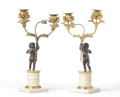 Lot 1199 - A Pair of French Parcel Gilt Bronze and White Marble Figural Candelabra, early 19th century,...