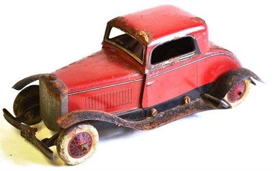Lot 38 - A Burnett Clockwork Tinplate Saloon Car, lithographed in red and black, with steering wheel and...