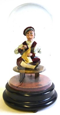 Lot 108 - A 19th Century Musical Automaton of a Seated Man Sewing, dressed in red velvet and grey silk,...