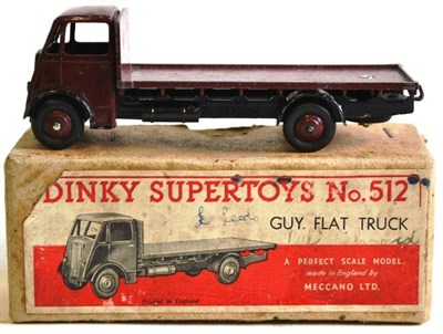 Lot 218 - A Boxed Dinky Supertoys Guy Flat Truck No.512, 1st cab type, with maroon cab, back and hubs,...