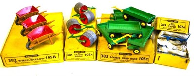 Lot 236 - Four Dinky Type 5 Accessory Trade Boxes - Wheel Barrows (3) No.382 and 105B, Garden Rollers (4)...