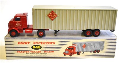 Lot 252 - A Boxed Dinky Supertoys McLean Tractor-Trailer No.948, with red cab, red hubs, plastic back, in...