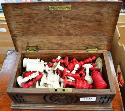 Lot 159 - An Ornately Turned Bone Chess Set, one side left natural, the other stained red, the 11.5cm...