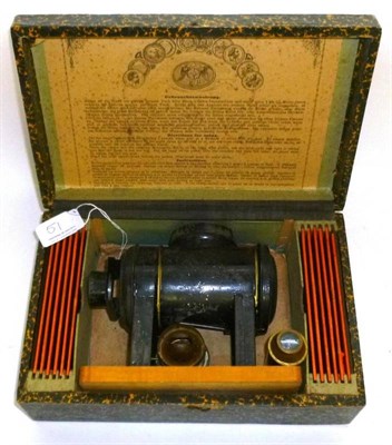 Lot 51 - A Boxed German Tinplate Toy Magic Lantern by Ernst Plank, with burner and slides, in wooden box...