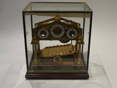 Lot 1289 - A Congreve Rolling Ball Clock, modern, the brass four columned frame with a central platform with a