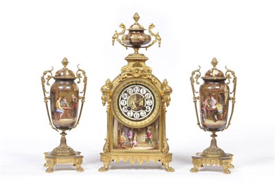 Lot 1295 - A Gilt Metal and Porcelain Mounted Clock Garniture, retailed by J T Barry, Cardiff, circa 1880, the