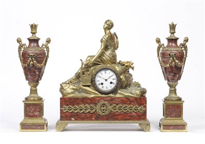 Lot 1296 - A French Gilt Metal and Red Marble Striking Mantel Clock with Garniture, circa 1870, the case...