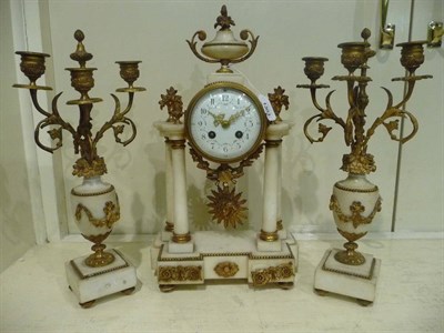 Lot 1303 - A White Marble Striking Mantel Clock with Garniture, circa 1890, the portico case surmounted by...