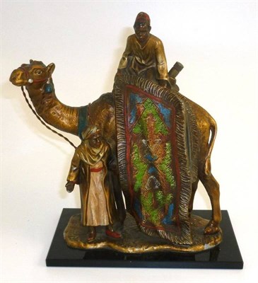 Lot 243 - A Cold Painted Spelter Strike-Lite Table Lighter in the Form of an Arab Carpet Seller, mounted on a