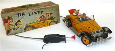 Lot 49 - A Boxed Arnold Mechanical Tinplate 'Tin Lizzy' Car, with yellow and black graffiti body, four...