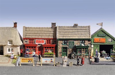 Lot 59 - A Village Main Street Diorama, with composition buildings, comprising a house, post office,...