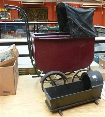 Lot 144 - A Vintage Dolls Pram, with maroon painted wooden body, black plastic hood, spoked wheels, white...