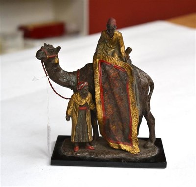 Lot 243 - A Cold Painted Spelter Strike-Lite Table lighter in the Form of an Arab Carpet Seller, mounted on a