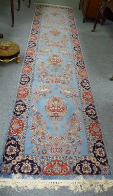 Lot 1344 - A Narrow Kashan Runner Central Persia The sky blue field with a column of lamps surrounded by birds