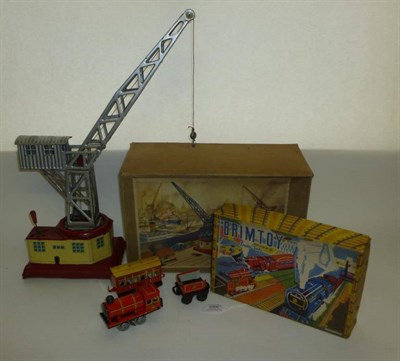 Lot 1066 - A Boxed German Clockwork Tinplate Dockland Crane, the silver crane mounted on a red and cream...