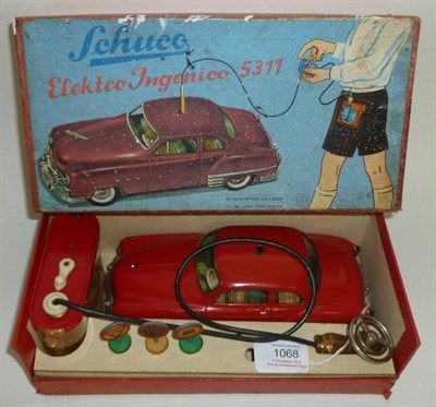 Lot 1068 - A Boxed Schuco Elektro Ingenico 5311 Car Driving Set, with red clockwork tinplate car, steering...