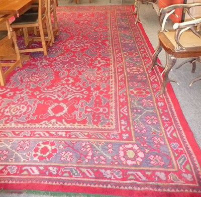 Lot 1353 - Donegal Carpet  Killibegs, West Ireland The blood red field with columns of skeletal medallions...