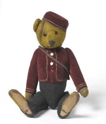 Lot 1121 - A 1920's Schuco Yes/No Bellhop Teddy Bear, with golden mohair head, hands and feet, glass eyes,...