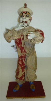 Lot 1124 - An Early 20th Century Clockwork Clown Automaton, with composition head and hands, wood and card...