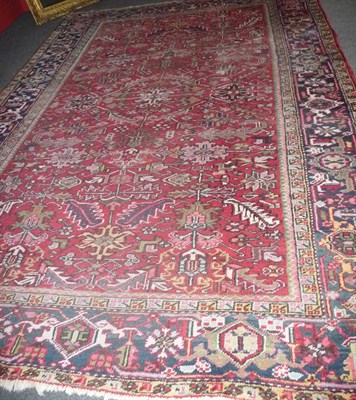 Lot 1355 - A Heriz Carpet Persian Azerbaijan The claret field with skeletal medallion framed by indigo samovar