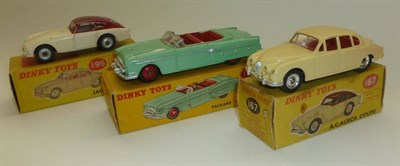 Lot 1220 - Three Boxed Dinky Cars:- Packard Convertible No.132, in light green with driver; Jaguar 3.4 Saloon