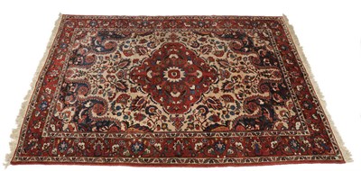 Lot 1372 - Bakhtiari Carpet  West Persia The mushroom coloured field of scrolling vines around a cusped madder