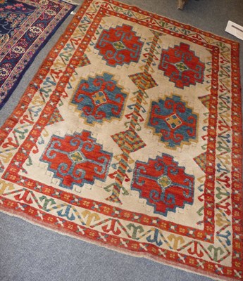 Lot 1378 - An Anatolian Rug of Kazak Design West Turkey The ivory field with two columns of stepped medallions