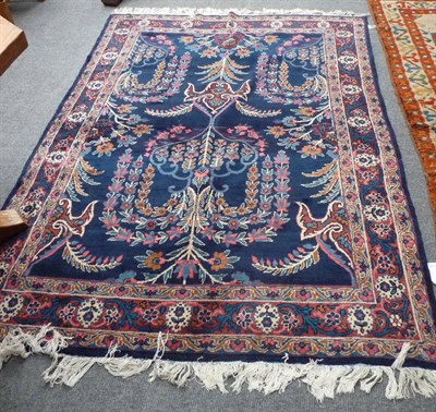 Lot 1379 - A Pair of Kirman Rugs South Persia Each with an indigo field of flowering vines enclosed by...