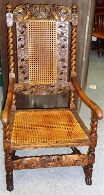 Lot 1383 - A Pair of Restoration Style Walnut Armchairs, with caned backs and seats, the carved and...