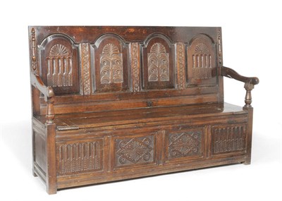 Lot 1392 - A Joined Oak Settle, the fielded panel back elaborately carved with stop fluting, guilloche columns