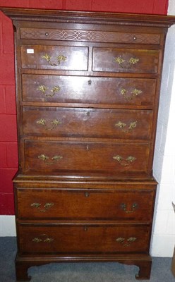 Lot 1394 - A George III Oak and Crossbanded Chest on Chest, the projecting dentil cornice above a blind...