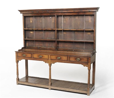 Lot 1397 - A George III Oak Enclosed Dresser and Rack, the projecting cornice above two fixed shelves with...